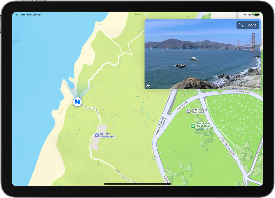 A moveable, 360-degree panoramic view appears above a map of the area marked in the Maps app. The Look Around icon overlaid on the map points in the direction of the view.